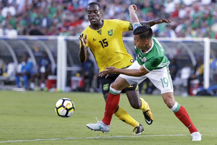 Mexico's Angel Sepulveda (19) and Jamaica's Je-Vaughn Watson battle for the ball during the second half of a CONCACAF Gold Cup semifinal soccer match in Pasadena, Calif. onSunday.