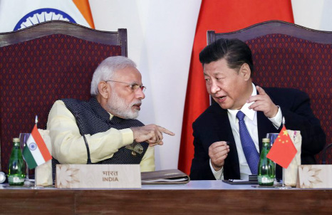 Indian Prime Minister Narendra Modi, left, and Chinese President Xi Jinping listen to a speech during the BRICS Leaders Meeting with the BRICS Business Council in Goa, India.