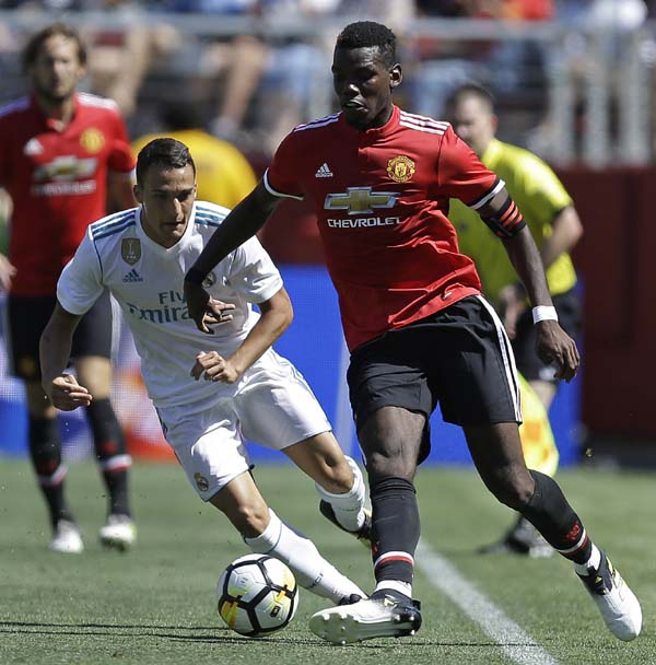 Manchester United's Paul Pogba (right) and Real Madrid's Luis Quezada fight for the ball during the second half of an international friendly soccer match in Santa Clara, Calif on Sunday.