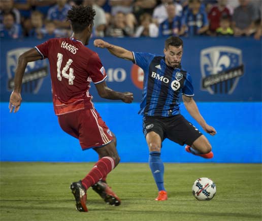 Montreal Impact's Blerim Dzemaili (right) gets set to shoot on the goal as FC Dallas' Atiba Harris defends during second-half MLS soccer game action in Montreal on Saturday.