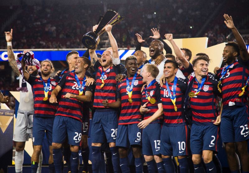 Captain of USA team Michael Bradley holds the trophy as he celebrates with teammates after defeating Jamaica on Wednesday.