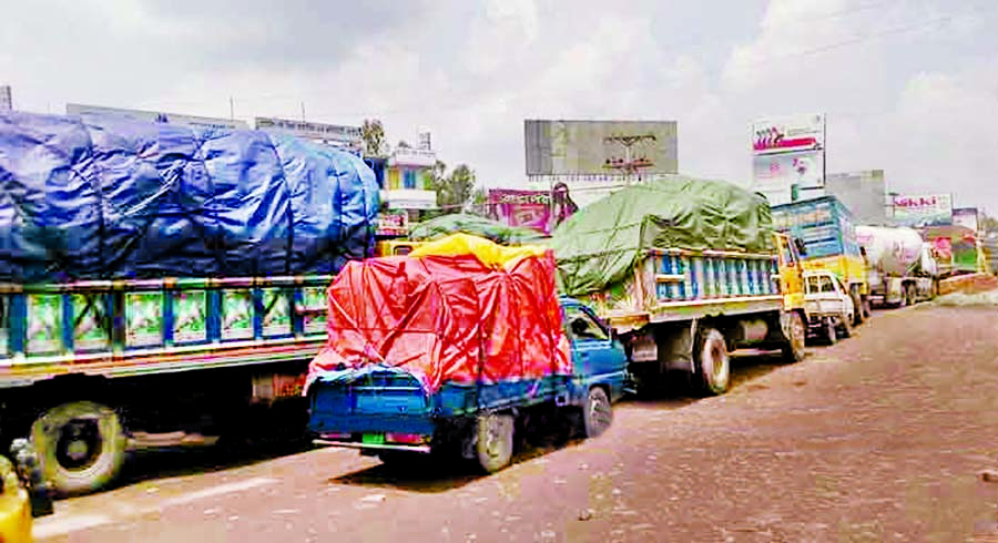 About 40 km tailback with hundreds of heavy vehicles including goods laden trucks got stuck for several hours on the western side of Bangabandhu Bridge, due to appalling situation of road. This photo was taken on Thursday.