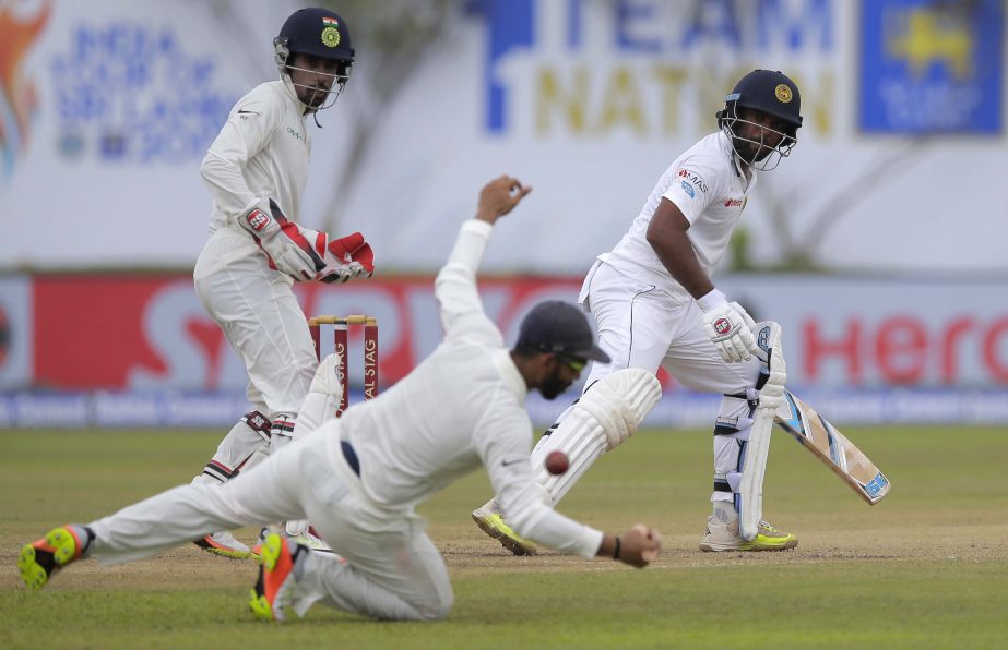 Sri Lanka's Dilruwan Perera watches his shot as India's Ajinkya Rahane attempts to stop the ball during the third day's play of the first test cricket match between India and Sri Lanka in Galle, Sri Lanka on Friday.