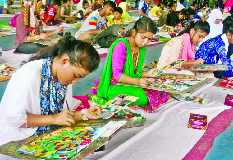 Participants engrossed in painting in a drawing competition organised by Bangladesh Olympic Association at Sheikh Russel Roller Skating Complex in the city on Friday marking Olympic Day-2017.