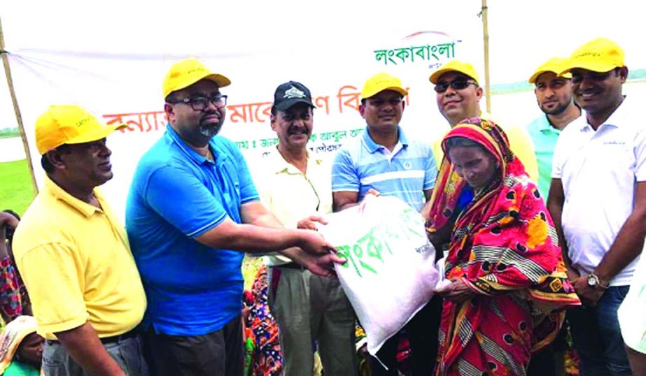 LankaBangla Foundatio, distributing more than 25 metric tons relief goods among the flood affected people of Ulipur Upazila in Kurigram on Friday. Head of Branch, Distribution and Management Division Mahbubur Rahman; Head of Liability Management, SM Abu