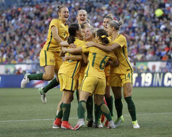 Australia players celebrate as they surround Tameka Butt, obscured, after she scored a goal against the United States during the second half of a Tournament of Nations women's soccer match in Seattle on Thursday. Australia won 1-0.