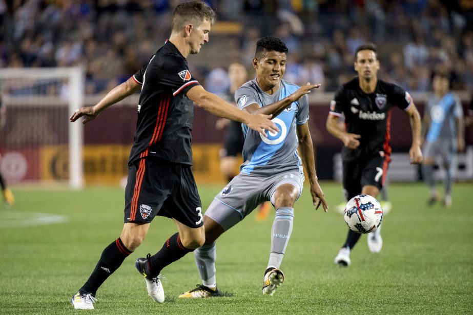 Minnesota United's Johan Venegas tries to maintain control of the ball during the second half of an MLS soccer game against D.C. United's Bobby Boswell in Minneapolis on Saturday.