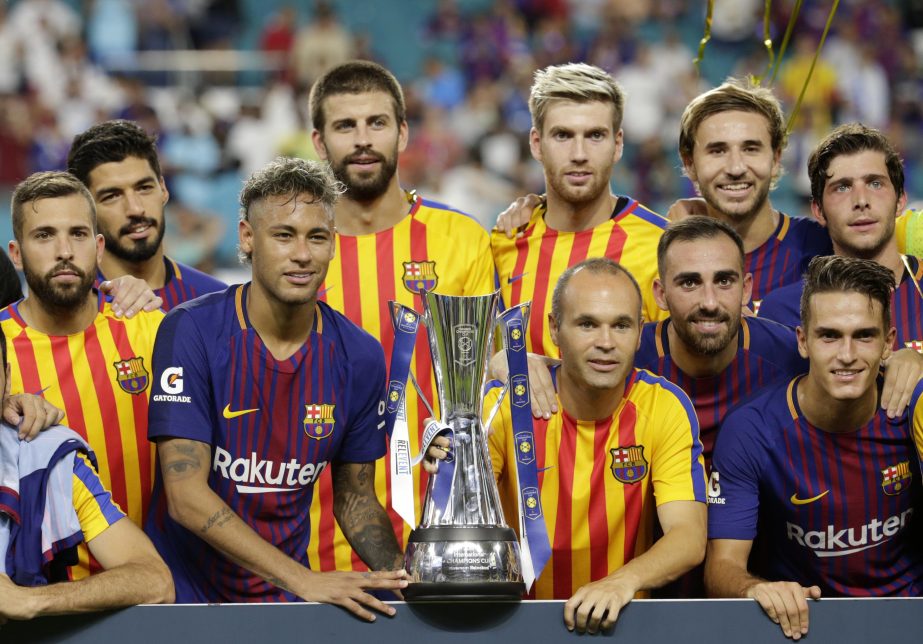 Barcelona's Neymar (second from left front) and teammates pose with the trophy after defeating Real Madrid in an International Champions Cup soccer match in Miami Gardens, Fla on Saturday.