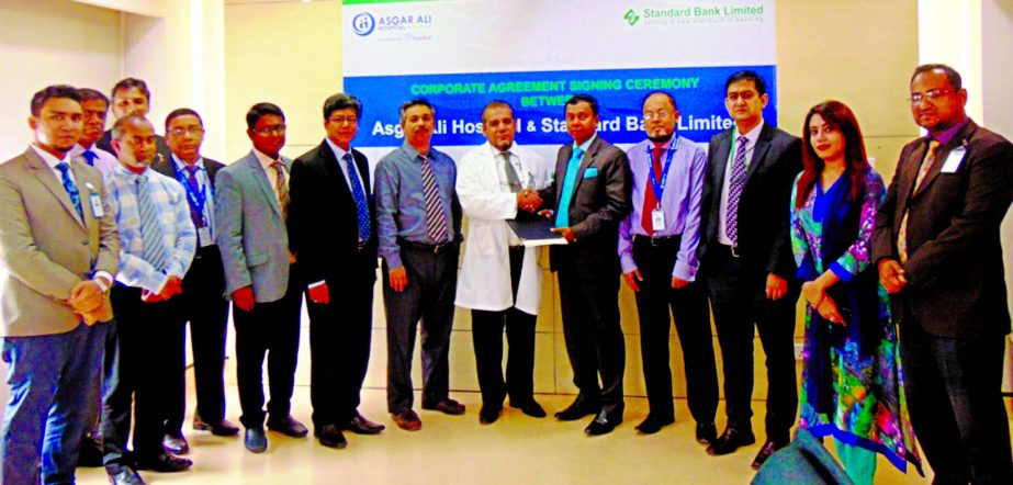 Sharif Zahirul Islam, Head of Cards of Standard Bank Limited and Prof. Dr. Zabrul SM Haque, CEO of Asgar Ali Hospital, exchanging an agreement signing documents at the banks head office recently. Under the deal, cardholders and employees of the bank will