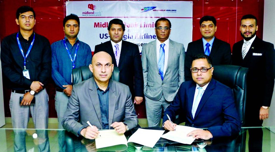 Md. Ridwanul Hoque, SVP of Midland Bank Limited and Sohail Majid, Deputy Director (Marketing & Sales) of US-Bangla Airlines signing an agreement at the bank's head office in the city on Sunday. Under the deal, Visa Credit Card holders of the bank will en