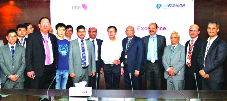 AE Abdul Muhaimen, Managing Director of UCB and Leo Zhuang, Managing Director of Liz Fashion Industry Ltd. shaking hands after inaugurating Internet Banking Service at the bank's head office in the city recently. Top officials from both the organizations