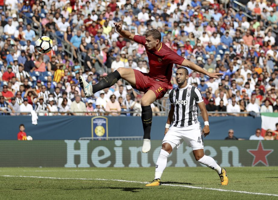 AS Roma's Edin Dzeko (9) kicks the ball ahead of Juventus' Medhi Benatia (4) during the first half of the International Champions Cup match in Foxborough, Mass on Sunday.