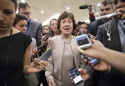 Sen. Susan Collins, R-Maine is surrounded by reporters as she arrives on Capitol Hill in Washington, before a test vote on the Republican health care bill. Collins, who was one of three Republican senators voting against the GOP health bill on Friday.