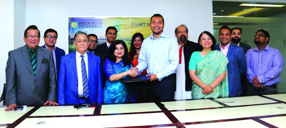 Farzana Chowdhury, CEO of Green Delta Insurance Ltd (GDIL), and Yasir Obaid, CEO of SylhetSixers exchanging a sponsorship agreement signing documents in the city on Monday. Under the deal, GDIL gets on board as a major sponsor of 'SylhetSixers' franchis
