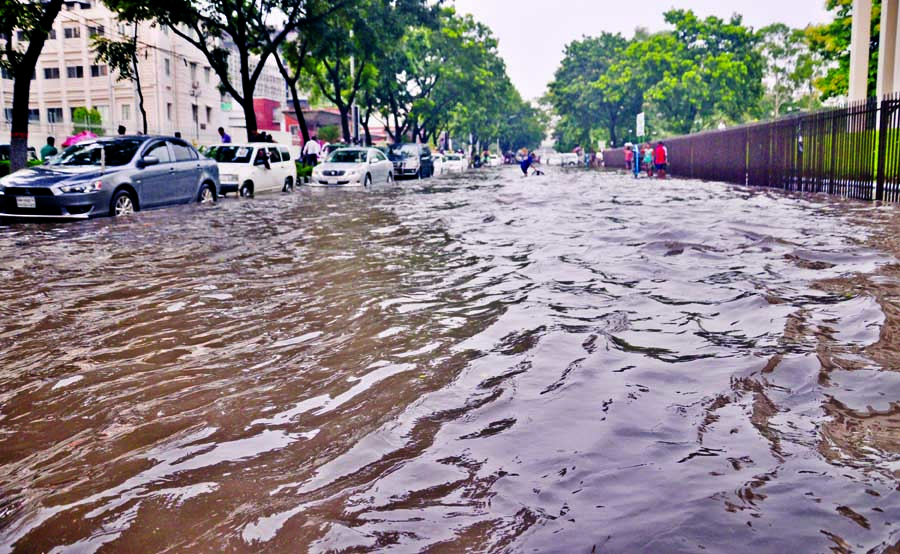 NOT A CANAL: Abdul Ghani Road beside the Secretariate turned into a virtual river after a brief rain on Tuesday afternoon.