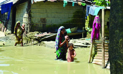 SYLHET: Children with their mothers are moving in flood water in South Surma Upazila. This snap was taken from Sonapur village in Moglabazar Union on Tuesday.