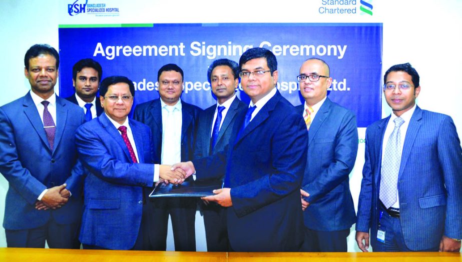 Makam E Mahmud Billah, Head of Retail Products and Segments of Standard Chartered Bank and MA Kabir, Managing Director of Bangladesh Specialized Hospital Ltd. exchanging a MoU signing documents at the bank's head office in the city on Tuesday. Under the