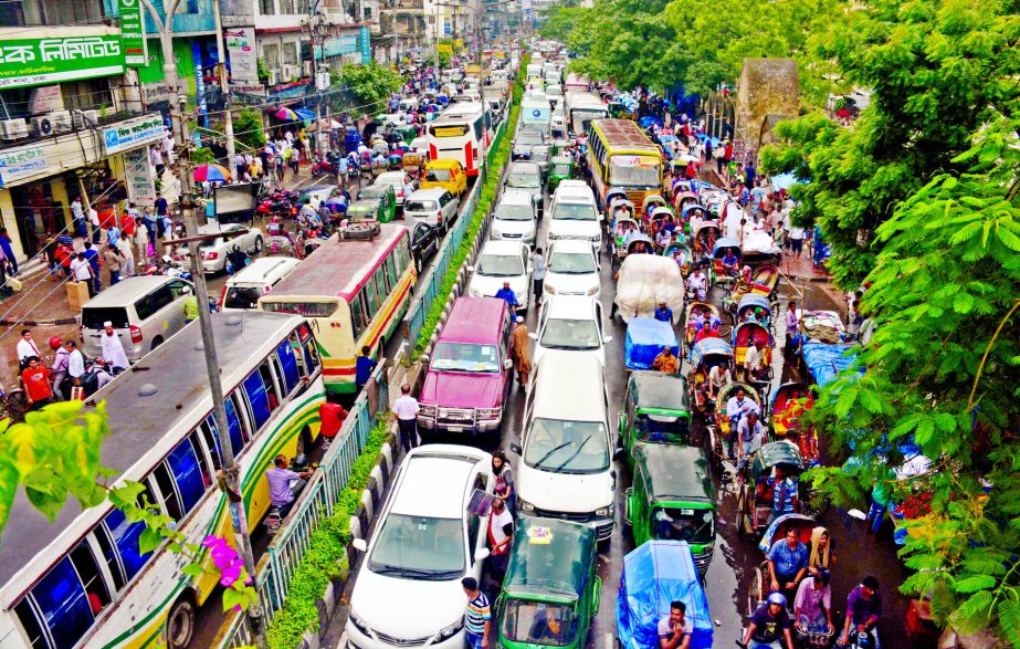 City experiences massive traffic gridlock due to heavy downpour as passengers immensely sufferings for hours. This photo was taken from Motijheel area on Wednesday.