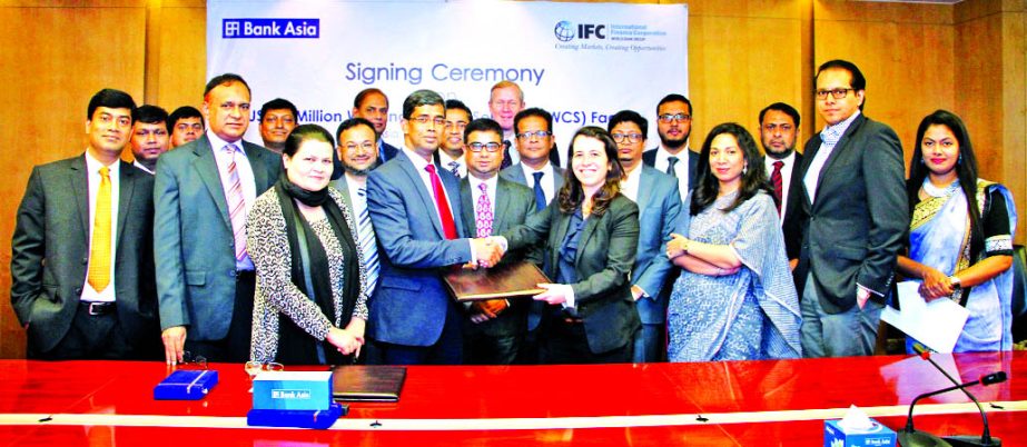 Md. Arfan Ali, Managing Director of Bank Asia Ltd, and Ariane Di Iorio, Manager and Head of Financial Institutions Group of International Finance Corporation, (South Asia) exchanging an agreement signing documents at the bank's head office in the city on