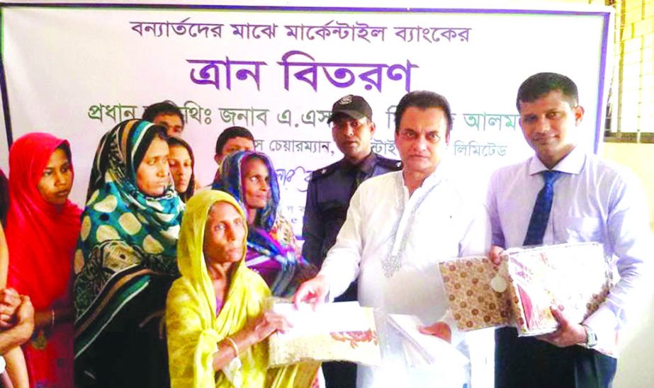 ASM Feroz Alam, Vice-Chairman of Mercantile Bank Limited, distributing relief among the flood affected people in different place at Kalaiya Union in Patuakhali on Thursday. Local elites were present.