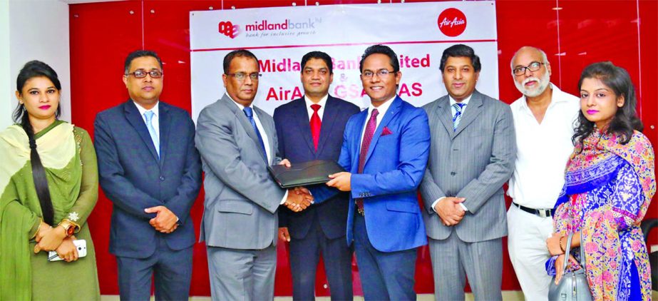Masihul Huq Chowdhury, Additional Managing Director of Midland Bank Limited and Morshedul Alam Chaklader, CEO of Total Air Services Limited, a Malaysian based airline inks a deal for special discount facility at the bank's head office on Thursday. Under