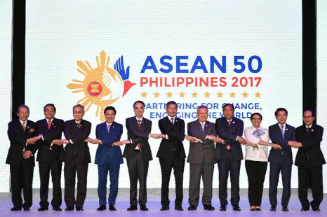 ASEAN Foreign Ministers link hands "The ASEAN Way" at the opening ceremony of the 50th ASEAN Foreign Ministers Meeting at the Philippine International Convention Center on Saturday in suburban Pasay city, south of Manila, Philippines. They are, from lef