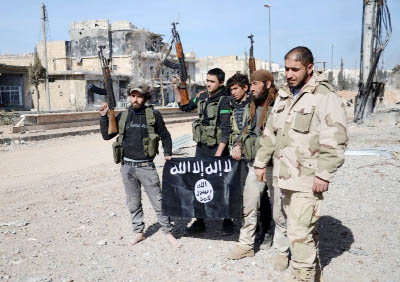 Abu Jaafar Â® and fellow Turkish-backed rebels pose with an Islamic State group flag as they advance towards the then jihadist-held city of Al-Bab.