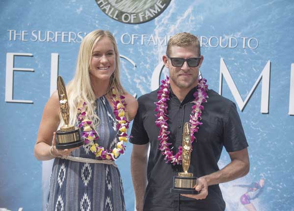 Surfers' Hall of Fame inductees Bethany Hamilton and Mick Fanning pose in Huntington Beach, Calif. on Friday.