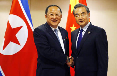 North Korean Foreign Minister Ri Yong Ho, left, poses with his Chinese counterpart Wang Yi for a photo prior to their bilateral meeting in the sideline of the 50th ASEAN Foreign Ministers' Meeting and its Dialogue Partners on Sunday in suburban Pasay cit