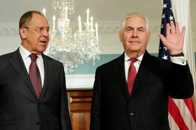 US Secretary of State Rex Tillerson Â® waves to the media next to Russian Foreign Minister Sergey Lavrov before their meeting at the State Department in Washington