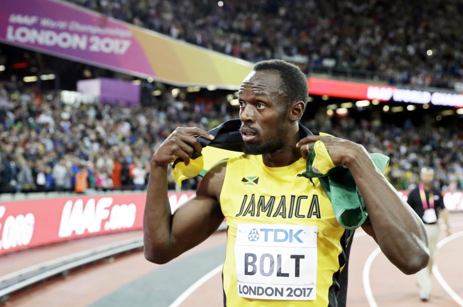 Jamaica's Usain Bolt holds his national flag after placing third in the men's 100m final during the World Athletics Championships in London on Saturday.