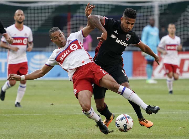 Toronto FC defender Justin Morrow (2) and D.C. United defender Sean Franklin (5) vie for control of the ball during the first half of an MLS soccer match in Washington on Saturday .