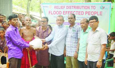 SYLHET: Leaders of Rotary Club of Sylhet distributing relief among the flood -hit people at Chilaura Haldipur Union recently.