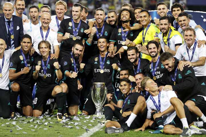 Real Madrid pose with the trophy after defeating Manchester United 2-1 during the Super Cup final soccer match at Philip II Arena in Skopje on Tuesday.