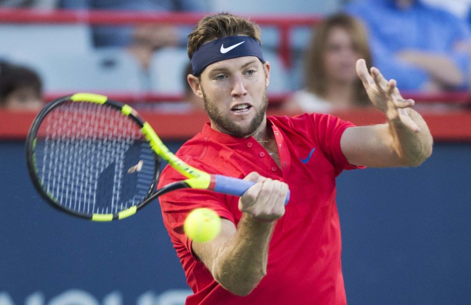 Jack Sock of the United States returns to Pierre-Hugues Herbert of France during the first round of the Rogers Cup tennis tournament in Montreal on Tuesday.