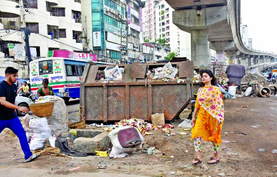 Overflowing garbage containers are seen at different intersections of the capital Dhaka narrowing main road and spreading bad odour all the time. This photo was taken from the Shantinagar area on Wednesday.