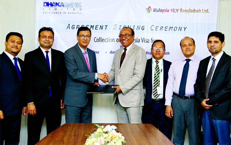 Akhlaqur Rahman, EVP of Dhaka Bank Ltd, and Hossain Mohammad Kawsar, Managing Director of Malaysia VLN Bangladesh Ltd. exchanging an agreement signing documents at the bank's head office in the city recently. Under the deal, as a payment aggregator, only