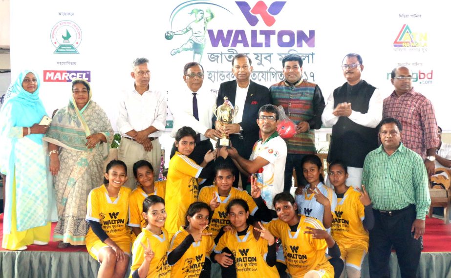 Members of Naogaon DSA, the champions of the Walton 4th National Youth Women's Handball Competition with the chief guest Secretary of Youth and Sports of Bangladesh Awami League Harunur Rashid and the other guests and officials of Bangladesh Handball Fed