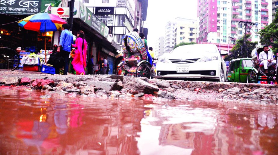 A big pothole and cracks developed and got waterlogged on the busy thoroughfare at Bailey Road intersection in city's posh area creating obstacles to movement of vehicles. This photo was taken on Friday.