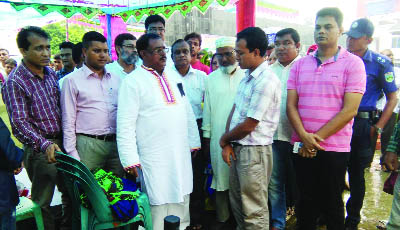 SAPAHAR (Noagaon): Babu Sadhaon Chandra Majumder MP visiting different stalls at the tree day- long Tree Fair in the Upazila on Friday.