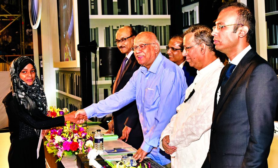 Finance Minister AMA Muhith, handing over the Dutch-Bangla Bank Scholarship among 4,032 students who passed SSCEquivalent Examination in 2017 and studying at H.S.C level in different colleges in the country at a city auditorium on Saturday. Law Minister