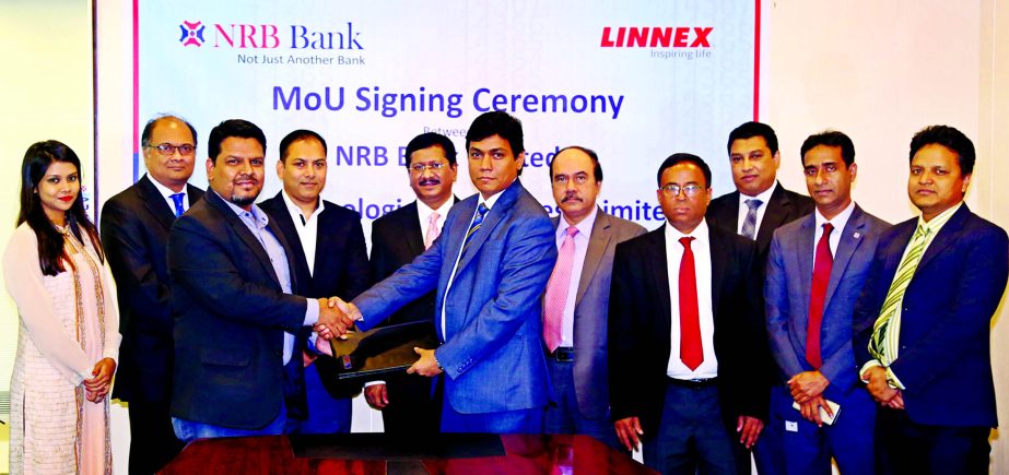 Md. Mehmood Husain, Managing Director of NRB Bank Limited and Golam Shahriyar Kabir, Chief Operating Officer of Linnex Technologies Limited, exchanging an agreement signing documents at the bank's head office in the city on Thursday. Under the deal, Debi