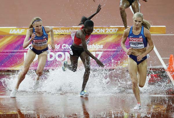 United States' Emma Coburn (right) and United States' Courtney Frerichs (left) pass by Kenya's Hyvin Kiyeng Jepkemoi in the women's 3000m steeplechase final during the World Athletics Championships in London on Friday.