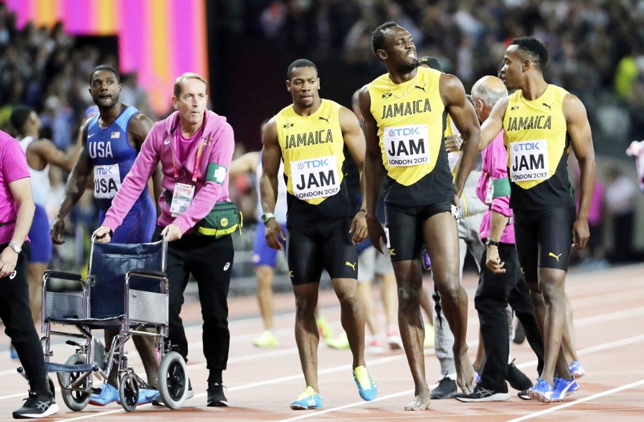 Jamaica's Usain Bolt (second right) walks with his teammates after he pulled up injured in the final of the Men's 4x100m relay during the World Athletics Championships in London on Saturday.