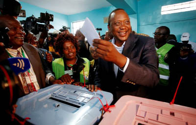 Kenya's President Uhuru Kenyatta casts his ballot inside a polling station in his hometown of Gatundu.
