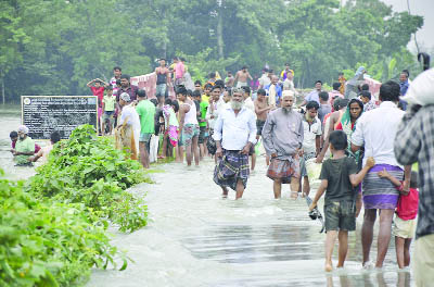 DINAJPUR: People are passing waterlogged Noshipur- Jamtoli Road in Dinahpur Sadar Upazila as the road has been broken due to heavy rainfall and hilly water yesterday.