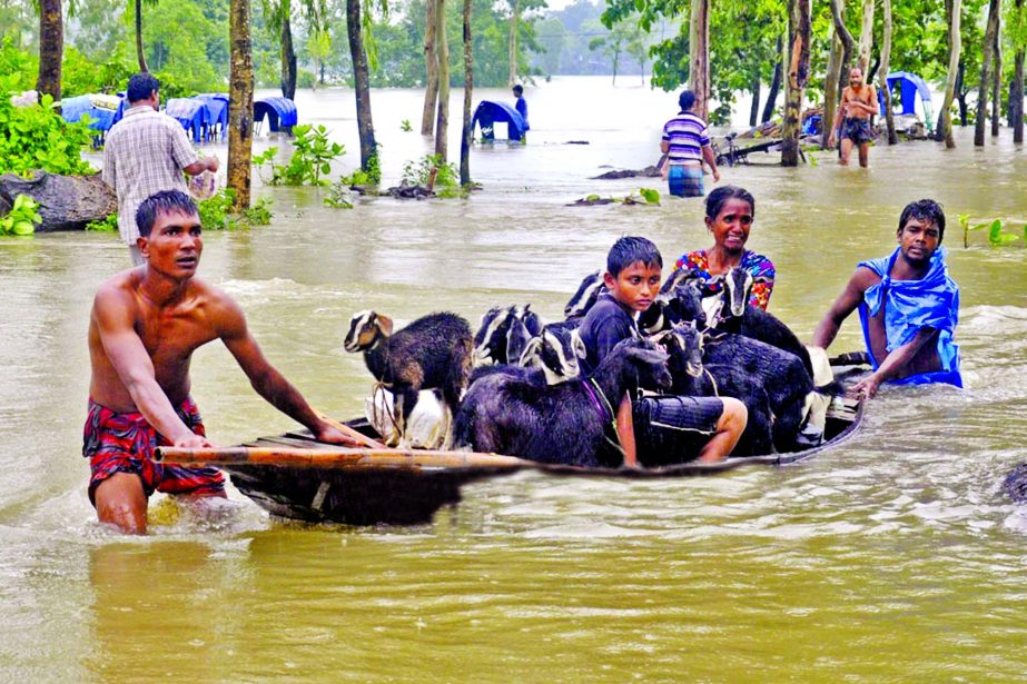 Flood situation worsens further as six embankments collapsed due to strong current in Teesta and Dharla rivers inundating fresh areas of the district. This photo was taken from Cherag Ali Mazar Road in Dinajpur district on Monday.