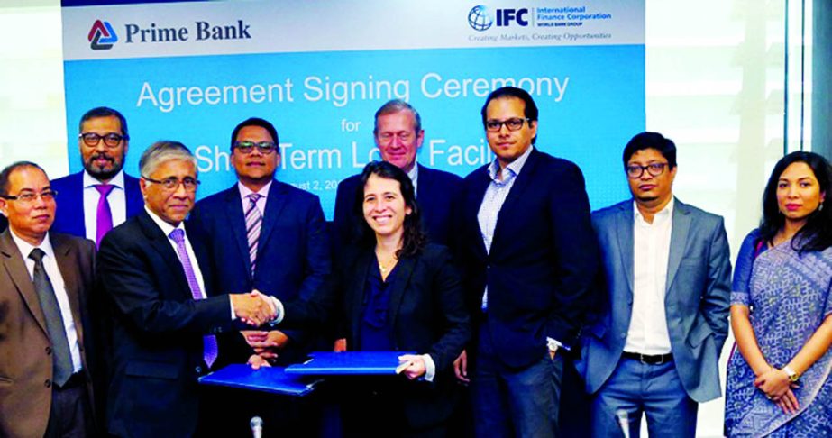Ahmed Kamal Khan Chowdhury, Managing Director of Prime Bank Ltd. and Ariane Di Iorio, Financial Institutions Group's Manager (South Asia) of IFC, (a member of the World Bank Group) exchanging an agreement signing documents at Prime Bank's head office in