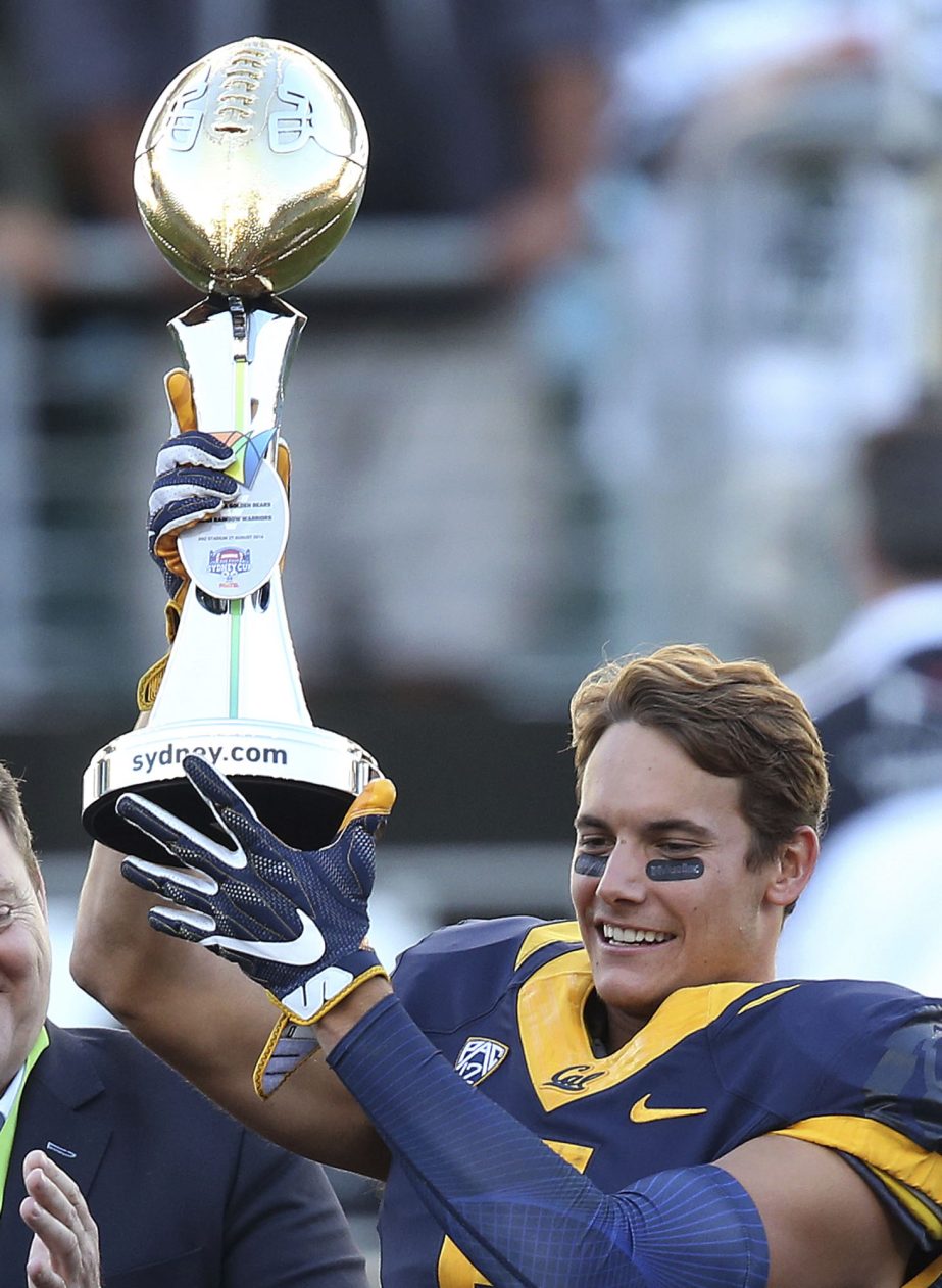 In this Aug. 27, 2016 file photo, California Golden Bears' Chad Hansen holds the trophy presented to his team after defeating the Hawaii Rainbow Warriors in the opening game of the U.S. college football season at Sydney's Olympic stadium in Sydney. Desp