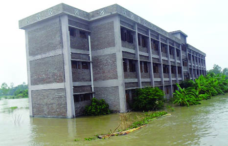 MANIKGANJ: Rustam Howlader High School situated at Char Madhanagar at Shibalaya in Manikganj district has been submerged due to flood. The photo was taken on Wednesday.